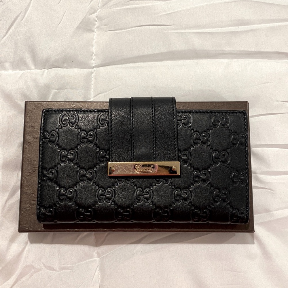 Gucci Guccissima wallet black with gold hardware.
